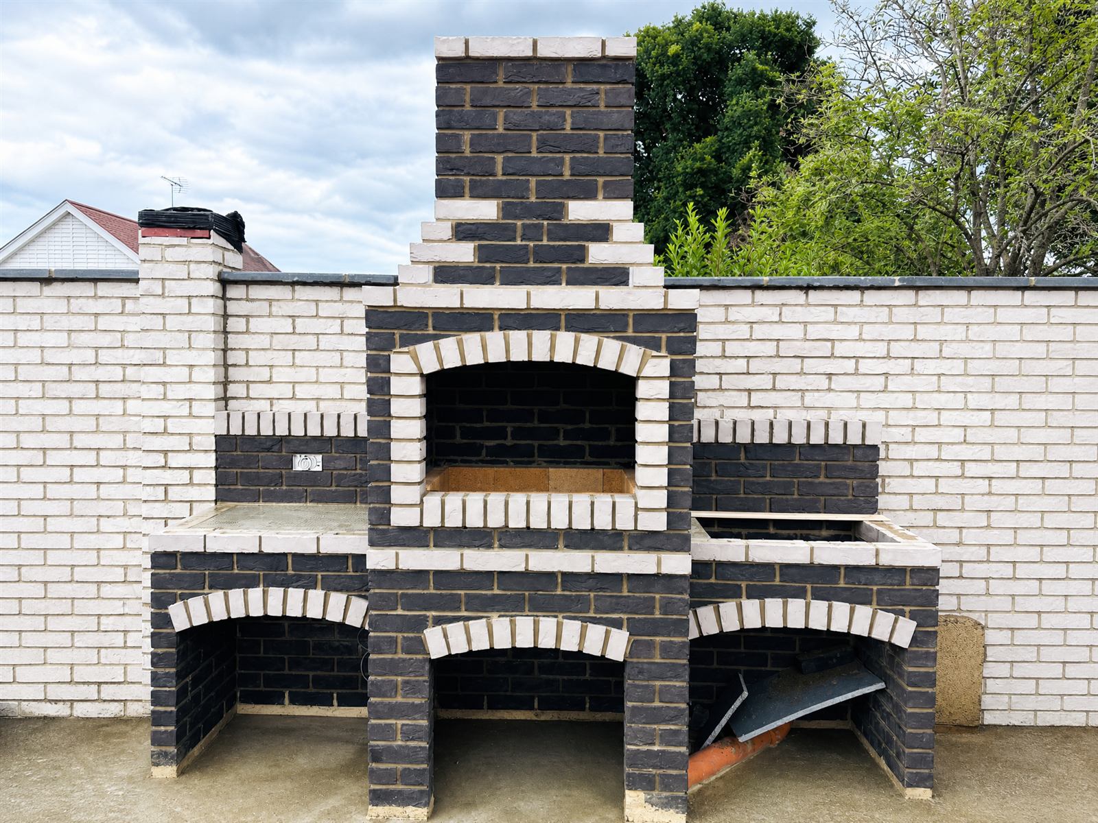 Bespoke outdoor brick BBQ with integrated worktops