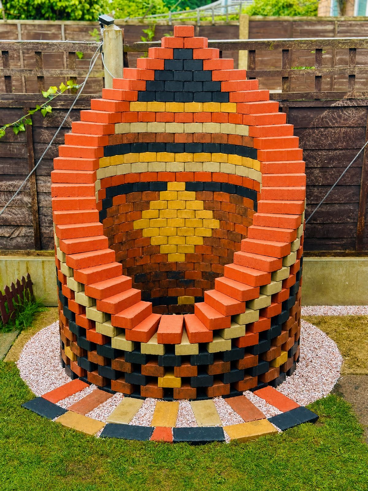 Colourful mosaic brick well feature